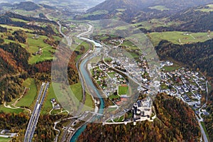 Aerial view of green meadows with villages and forest in austrian Alps mountains