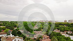 Aerial view on green trees and city panorama, San Isidro