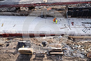 Aerial view of group of workers on construction site, working.