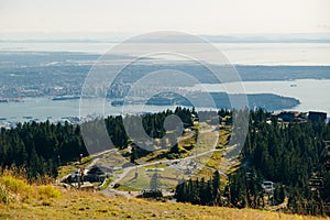 Aerial View of Grouse Mountain with Downtown city. North Vancouver, BC, Canada