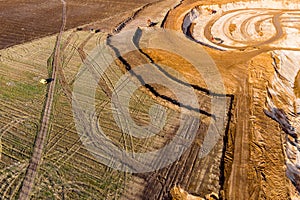 Aerial view of a growing sand pit at the expense of fields