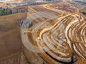 Aerial view of a growing sand pit at the expense of fields