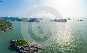Aerial view of Ha Long Bay from Cat Ba island, famous tourism destination in Vietnam. Scenic blue sky with clouds, limestone rock