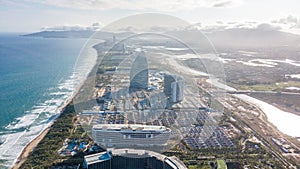 Aerial view of Haitang Bay, Sanya, Hainan, China. Top View of luxury beach with palm trees against the background of the beauty of