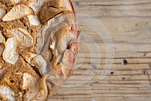 Aerial view of half apple pie, on wooden table, selective focus, horizontal,