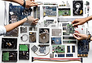 Aerial view of hands with computer electronics parts on white background