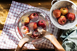 Aerial view of hands washing apples in bowl