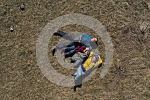 Aerial view of a happy family with, mom, dad and two kids laying in the grass