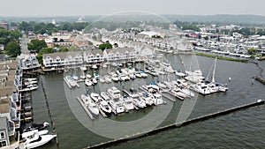 aerial view of the harbor area of a town surrounded by boats