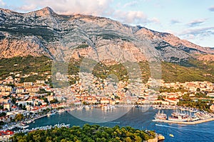 Aerial view of the harbor and old town, Makarska, Dalmatia, Croatia. Travel background with yachts, sea, architecture and rocks