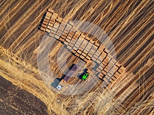 Aerial view of harvest field and hay bales