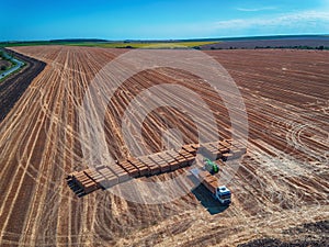 Aerial view of harvest field and hay bales