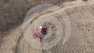 Aerial view harvester working on corn field. Autumn agricultural harvesting work.