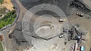 Aerial view of heavy machinery for crushing and collecting stone gravel materials for asphalt producers recycle and