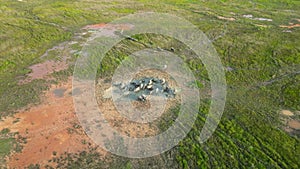 An aerial view of a herd of buffaloes in a field