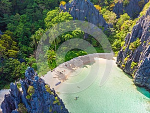 Aerial view of Hidden beach in Matinloc Island, El Nido, Palawan, Philippines - Tour C route - Paradise lagoon and beach in