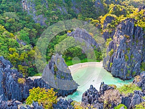 Aerial view of Hidden beach in Matinloc Island, El Nido, Palawan, Philippines - Tour C route - Paradise lagoon and beach in