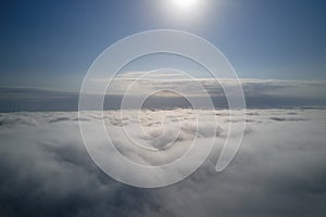 Aerial view from high altitude of earth covered with puffy rainy clouds forming before rainstorm