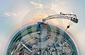 Aerial view from high altitude of little planet earth with cement factory tower with high concrete plant structure at