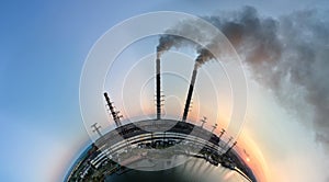 Aerial view from high altitude of little planet earth with coal power plant high pipes with black smokestack polluting