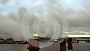 Aerial view of high chimney pipes with grey smoke. Chimneys Plant at Sunset. Air Pollution Concept.