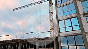 Aerial view of high residential apartment building under construction. Real estate development.