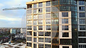 Aerial view of high residential apartment building under construction. Real estate development.