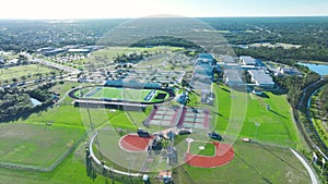 Aerial view of high school open air sports facilities in North Port, Florida. American football stadium, tennis court