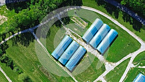Aerial view high tunnel greenhouse on large grassy vacant land of large commercial farm in rural Ozarks aera, Mansfield photo