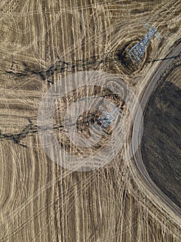 Aerial view of High-voltage power transmission towers over farm fields