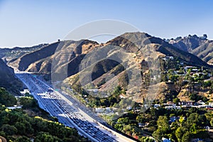 Aerial view of highway 405 with heavy traffic; the hills of Bel Air neighborhood in the background; Los Angeles, California