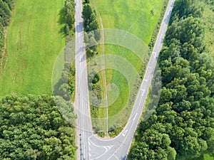 Aerial view of highway. Aerial view of a country road. Car passing by. Aerial road. Aerial view flying. Captured from above with