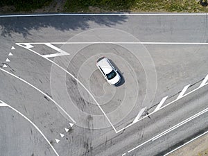 Aerial view of highway. Aerial view of a country road with moving car. Car passing by. Aerial road. Aerial view flying. Captured