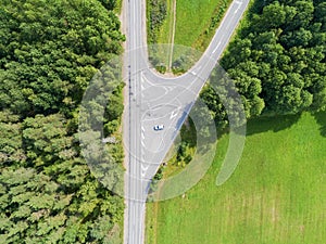 Aerial view of highway. Aerial view of a country road with moving car. Car passing by. Aerial road. Aerial view flying. Captured