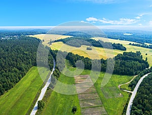 Aerial view of highway. Aerial view of a country road near the lake. Car passing by. Aerial road. Aerial view flying. Captured fro