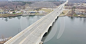 Aerial view of a highway bridge over the river next to a town