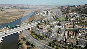 Aerial view of a highway with cars and nearby buildings in Petaluma, California