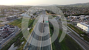 Aerial view of a highway with cars and nearby buildings in Petaluma, California