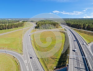 Aerial view of highway in city. Cars crossing interchange overpass. Highway interchange with traffic. Aerial bird`s eye photo of