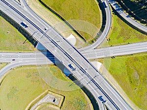 Aerial view of highway in city. Cars crossing interchange overpass. Highway interchange with traffic. Aerial bird`s eye photo of