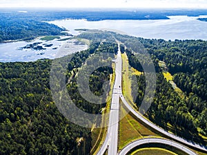 Aerial view of highway in city. Cars crossing interchange overpass. Highway interchange with traffic. Aerial bird`s eye photo of