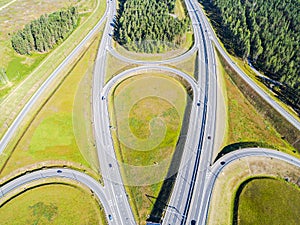 Aerial view of highway in city. Cars crossing interchange overpass. Highway interchange with traffic. Aerial bird`s eye photo of