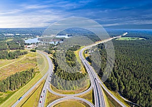 Aerial view of highway in city. Cars crossing interchange overpass. Highway interchange with traffic. Aerial bird`s eye photo of