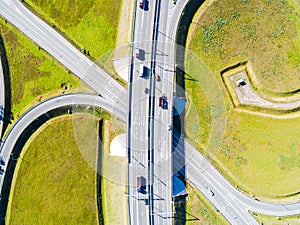 Aerial view of highway in city. Cars crossing interchange overpass. Highway interchange with traffic. Aerial bird`s eye photo of