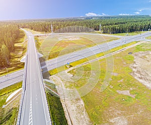 Aerial view of highway in city. Cars crossing interchange overpass. Highway interchange with traffic. Aerial bird`s eye photo of