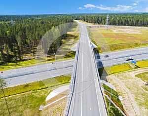 Aerial view of highway in city. Cars crossing interchange overpass. Highway interchange with traffic. Aerial bird`s eye photo of