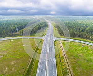 Aerial view of highway in city. Cars crossing interchange overpass. Highway interchange with traffic. Aerial bird`s eye photo of