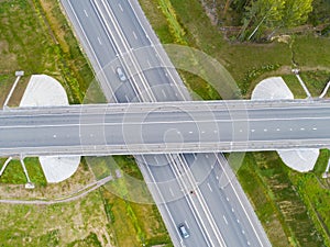 Aerial view of highway in city. Cars crossing interchange overpass. Highway interchange with traffic. Aerial bird`s eye photo of