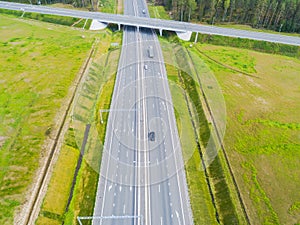 Aerial view of highway in city. Cars crossing interchange overpass. Highway interchange with traffic. Aerial bird`s eye photo of