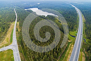 Aerial view of highway in city. Cars crossing interchange overpass. Highway interchange with traffic. Aerial bird`s eye photo of